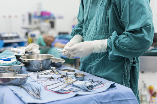 scrub nurse preparing surgical instruments for operation
