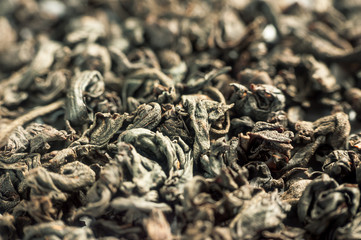 Pile of aromatic green tea as background closeup