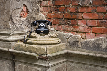 Old phone on a dilapidated wall