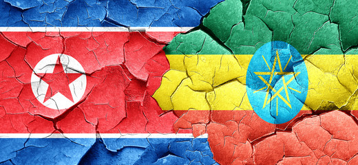 North Korea flag with Ethiopia flag on a grunge cracked wall