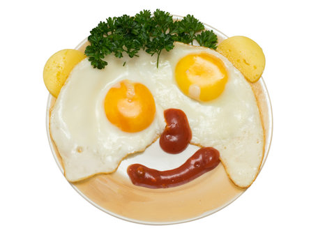 funny faces from eggs with cheese and sauce isolated