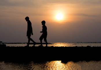Group of child walking at sunset on the beach