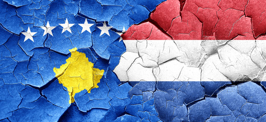 Kosovo flag with Netherlands flag on a grunge cracked wall