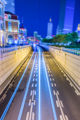 light trails with skysrapers background,tianjin china.