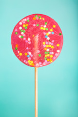 Big red lollipop on blue background