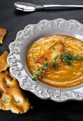 detail of carrot soup recipe with focaccia and marjoram over sla
