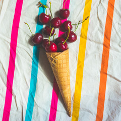 ice cream cone with cherries, vibrant background, summer health