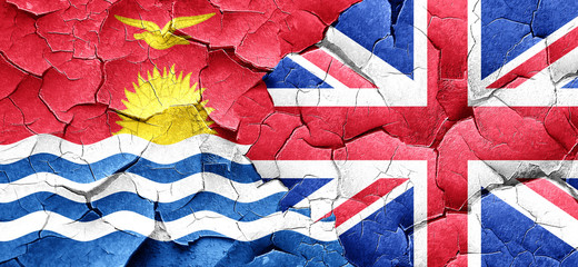 Kiribati flag with Great Britain flag on a grunge cracked wall