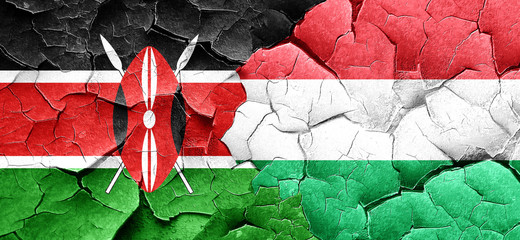 Kenya flag with Hungary flag on a grunge cracked wall