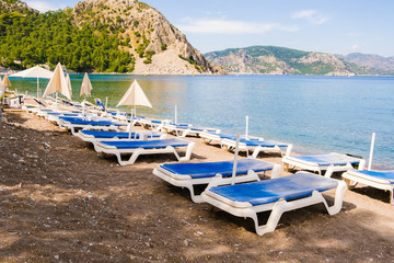Fototapeta na wymiar Sunbeds in Marmaris beach at Turkey