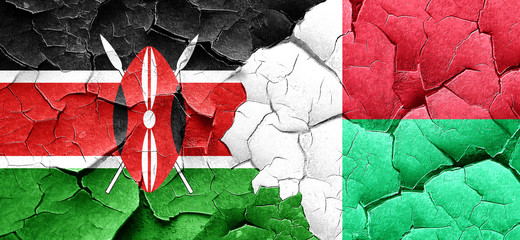 Kenya flag with Madagascar flag on a grunge cracked wall