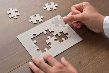 Folding puzzle hand parts on a wooden table