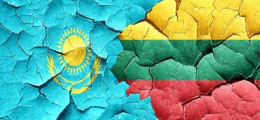 Kazakhstan flag with Lithuania flag on a grunge cracked wall