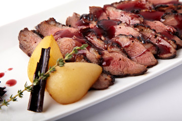Grilled meat with pear on a white background
