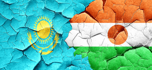 Kazakhstan flag with Niger flag on a grunge cracked wall