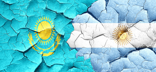 Kazakhstan flag with Argentine flag on a grunge cracked wall