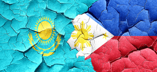 Kazakhstan flag with Philippines flag on a grunge cracked wall