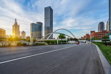 Obraz premium modern buildings with empty road under blue sky,tianjin china.