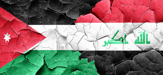 Jordan flag with Iraq flag on a grunge cracked wall