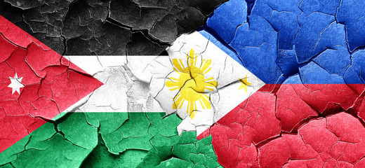 Jordan flag with Philippines flag on a grunge cracked wall