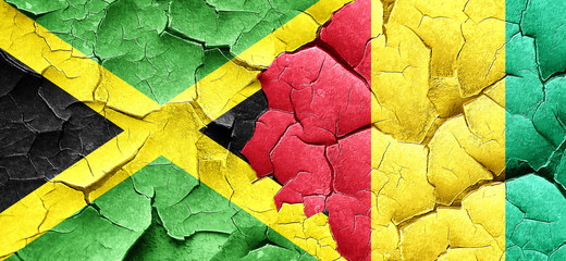 Jamaica flag with Guinea flag on a grunge cracked wall