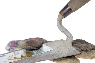 minimum wage / Brick trowel with work gloves and eight euro fifty