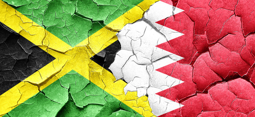 Jamaica flag with Bahrain flag on a grunge cracked wall