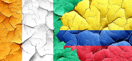 Ivory coast flag with Colombia flag on a grunge cracked wall