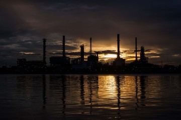 Fototapeta premium Oil refinery factory in Silhouette view.