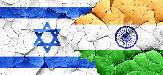 Israel flag with India flag on a grunge cracked wall