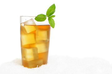 Ice tea with ice cubes,mint on snow on white