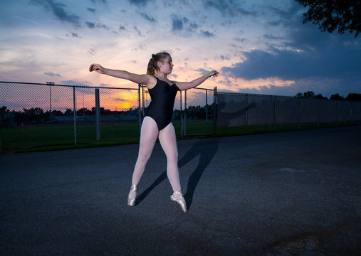 Young Tween Caucasian Girl practices Ballet in her Backyard