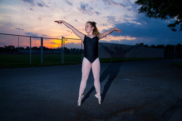 Fototapeta na wymiar Young Tween Caucasian Girl practices Ballet in her Backyard