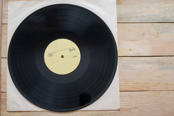 Vinyl record with copy space in front of a collection albums dummy titles, vintage process