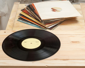 Vinyl record with copy space in front of a collection albums dummy titles, vintage process