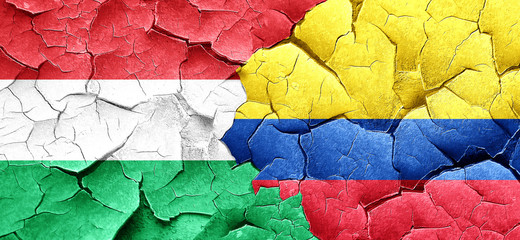 Hungary flag with Colombia flag on a grunge cracked wall