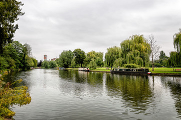 Beautiful river with boats in a green park