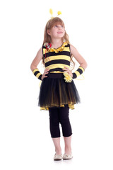 Happy girl is wearing costume of yellow and black bee on white b