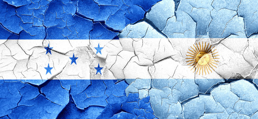 Honduras flag with Argentine flag on a grunge cracked wall
