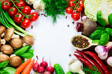 Beautiful background healthy organic eating. Studio photography the frame of different vegetables and mushrooms with a white sheet of paper on the old brown boards with free space