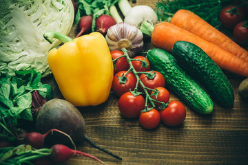 Beautiful background healthy organic eating. Studio photography of different vegetables and mushrooms on the old brown boards