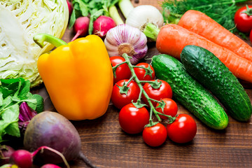 Beautiful background healthy organic eating. Studio photography of different vegetables and mushrooms on the old brown boards