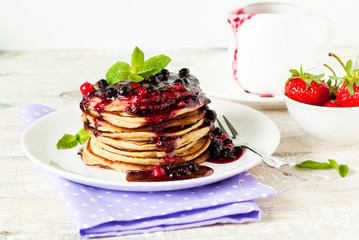 Stack of pancakes topped with berry jam