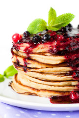 Stack of pancakes topped with berry jam