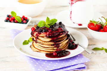 Stack of pancakes topped with berry jam