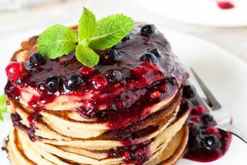 Stack of pancakes topped with berry jam