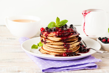 Stack of pancakes topped with berry jam