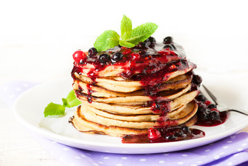 Stack of pancakes topped with berry jam