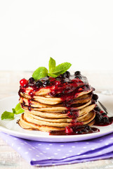 Stack of pancakes topped with berry jam