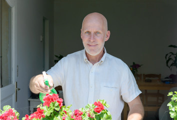 mature man watering the flowers